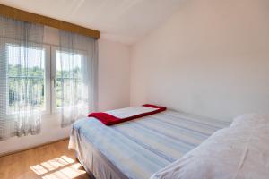 Postel nebo postele na pokoji v ubytování Apartments Kronja