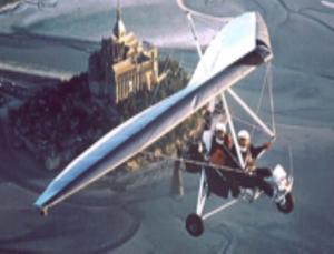 two people in a biplane flying over a castle at Maison d'hôtes Les Vallées in Saint-Quentin-sur-le-Homme