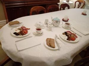 a white table topped with plates of food at Abbeyview House in Abbeyshrule