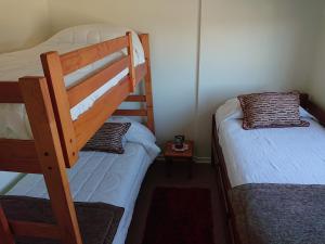 En eller flere senge i et værelse på Apartment Villarrica Holidays