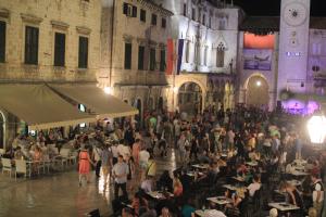 a crowd of people sitting at tables in a building at Apartment 4 You in Dubrovnik