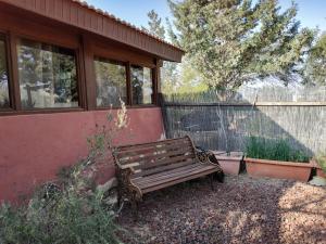 a wooden bench sitting outside of a house at Desert Peace in Mitzpe Ramon