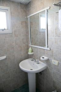 a bathroom with a sink and a mirror at Hotel del Mar in Valeria del Mar