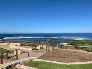 a boardwalk leading to the beach with the ocean in the background at By the Sea Margaret River in Gnarabup