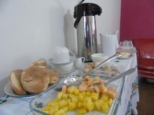 a table topped with plates of food on a table at Pousada Villa Huaripampa in Jauja