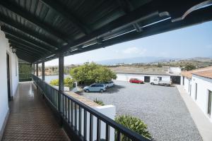 a balcony with cars parked in a parking lot at Casa Rural La Higuera Mayor in Telde