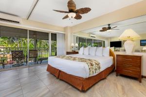 
a bedroom with a large bed and a large window at Castle Waikiki Shore Beachfront Condominiums in Honolulu
