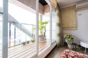 a bedroom with a large window with plants on it at Star Hotel in Kaohsiung
