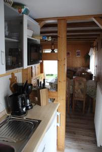 a kitchen with a stove and a counter top at Ferienhaus Neubert in Wolkenstein