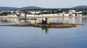 a island in the water with a sign that reads find us here at Blueberry Two Bedroom Suite for 1, 2 or 3 people in Douglas