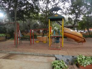 a playground with a slide and a monkey on top at Sayeban Hotel in Matheran