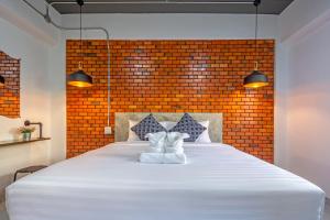 a bedroom with a large white bed with two white shoes at BA​ Apartment​ Flow​Suvarnabhumi in Bang Phli