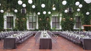 a room filled with tables and chairs with plants at Zamek Joannitów in Łagów