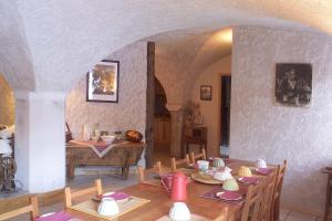 a dining room with a table and chairs in a house at La Roche Meane in Villar-dʼArène