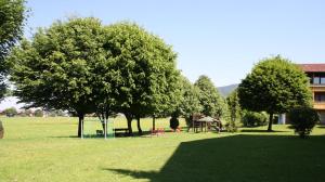 a park with trees and a playground and a building at Chiemgau Appartements in Inzell