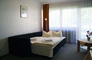 a hotel room with a bed and a window at Chiemgau Appartements in Inzell +28 photos
