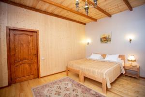 a bedroom with a bed and a dresser at MagHay B&B in Vanadzor