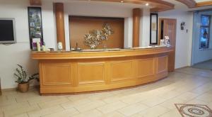 a lobby with a large wooden counter in a salon at Öko-Landhotel Basler Hof in Lauterbach +101 photos