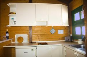 a kitchen with white cabinets and a sink at Apartamentos Santa Ana - Adults Only in Playa de Santiago