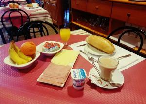 a table with plates of food and fruit on it at Hotel Sonia Chipude in El Cercado