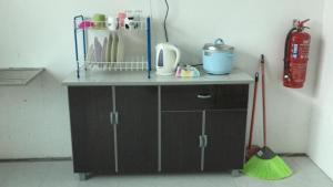 a cabinet with a broom and a fire hydrant at GERIK HOMESTAY in Gerik