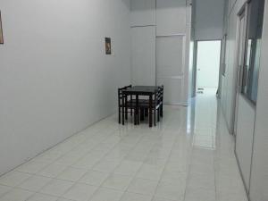 a white tiled floor with a table and chairs in a room at GERIK HOMESTAY in Gerik +23 photos
