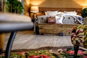 a bedroom with a bed and a table with a lamp at Valsana Hotel Arosa - Small Luxury Hotels of the World in Arosa +50 photos