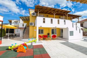 a house with a playground in front of it at Villa Elpis 2 in Limenaria