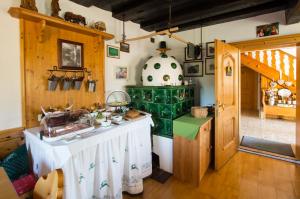 a kitchen with a table and a stove at Reiterhof Suassbauer in St. Wolfgang