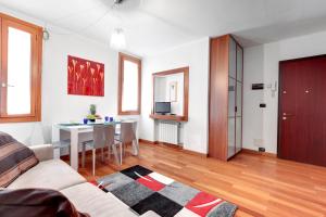 a living room with a couch and a table at Fenix Do Dogi Apartments in Venice