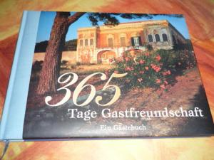 a book sitting on top of a table with a house at Gästehaus Rosengarten im Nahetal in Kirn