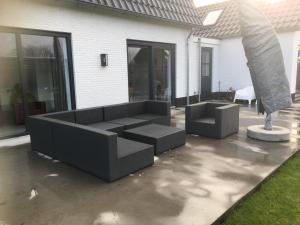 dois sofás sentados num pátio em frente a uma casa em Vierdaagse slaapplaatsen 2-6 personen em Beuningen