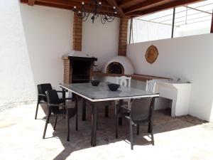 a dining room with a table and chairs and a fireplace at Las Arecas Mansion in Playa Blanca