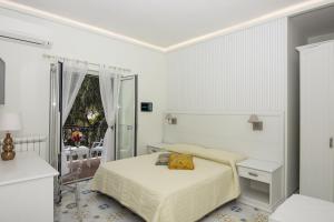 A bed or beds in a room at Ambra Sorrento Suites Short Rent