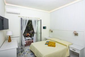 A bed or beds in a room at Ambra Sorrento Suites Short Rent