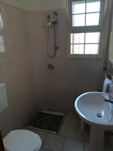 a bathroom with a sink and a toilet and a shower at Resort dei Lillà Pugliaresort in San Pietro in Bevagna