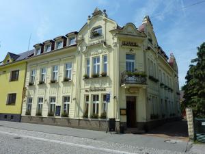 a yellow building on the side of a street at Hotel & Restaurant Na Fryštátské in Karviná