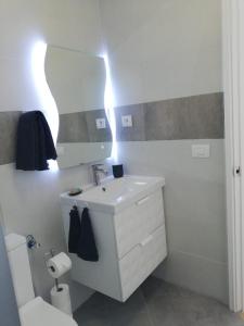 a bathroom with a sink and a mirror and a toilet at Mar Paraiso in Playa del Cura