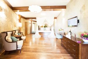 a large room with a salon with a bed at Tulia Zanzibar Unique Beach Resort in Pongwe