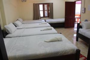 Säng eller sängar i ett rum på Pakbeng Guesthouse