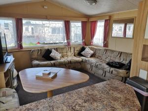 a living room with a couch and a table at 8 Berth Caravan Northshore Skegness Rio in Skegness