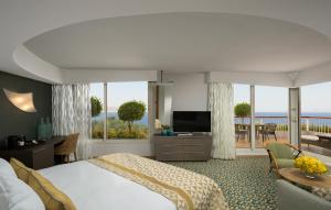 a hotel room with a bed and a view of the ocean at Dan Eilat Hotel in Eilat