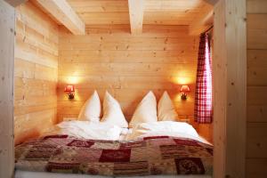 a bedroom in a log cabin with a bed in it at Chalet Sonnheim in Lofer