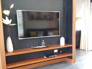 a flat screen tv sitting on top of a entertainment center at Forest Lodge: Little Villa in Agnes Water