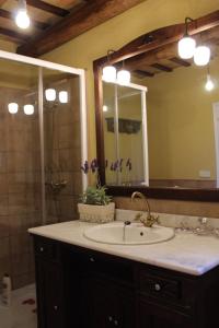 a bathroom with a sink and a mirror and a shower at CAN SIMON in San Dalmay