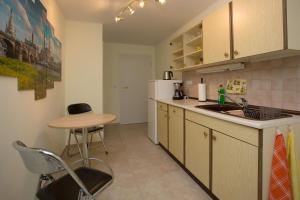a kitchen with a table and a sink and a table at Ferienwohnung Moritzburg in Boxdorf +2 photos