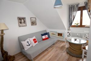 ein Wohnzimmer mit Sofa und Tisch in der Unterkunft Apartament MORSKA PRZYSTAŃ in Ustka