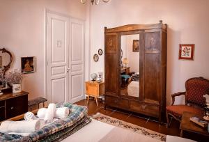 a living room with a couch and a large mirror at Athens Quinta in Athens +40 photos