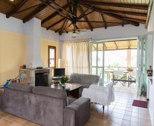 a living room with a couch and a fireplace at Villa with private garden in Kréstena