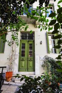 a green door leading to a small house at Athens Quinta in Athens